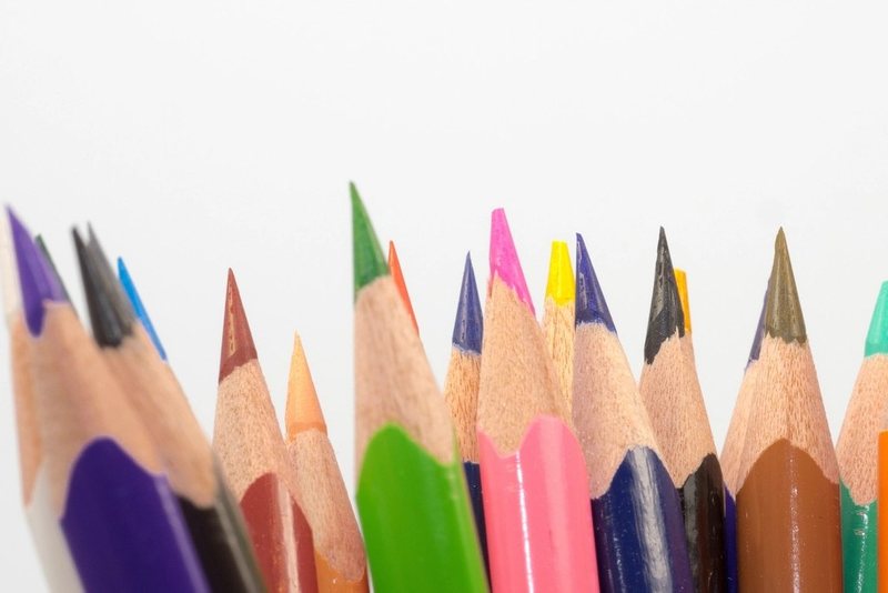 Close-up of sharpened coloured pencils against a white background