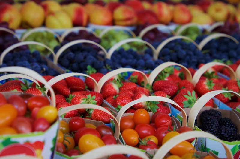 Baskets of fresh berries and other fruit at a produce stall