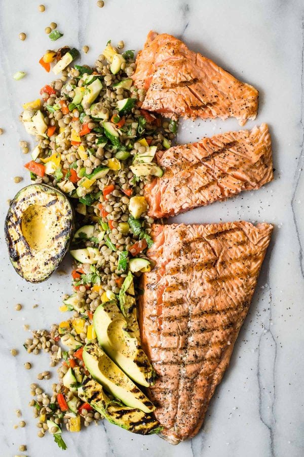 Salmon fillets served with lentils and greens
