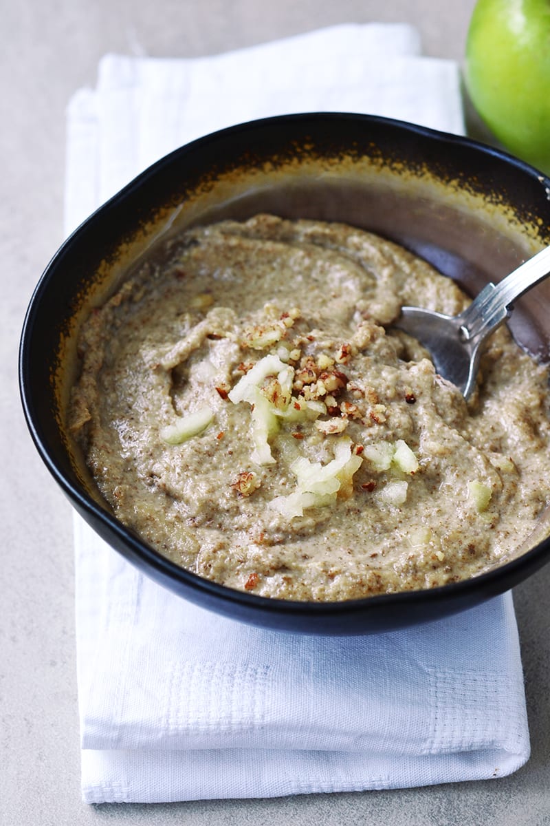 A bowl of porridge with seeds and fruit
