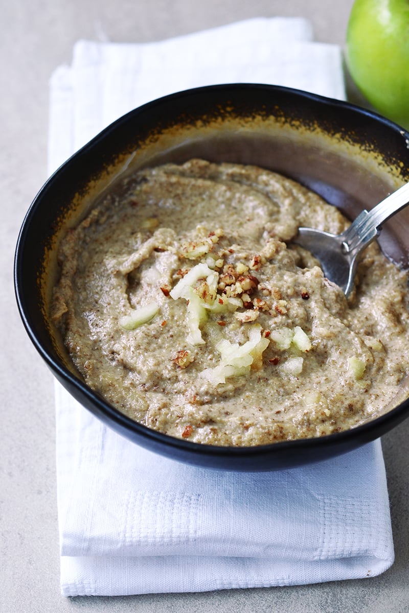 A bowl of porridge with seeds and fruit