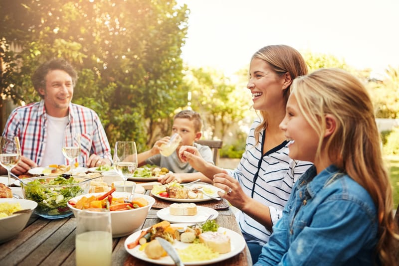Friends sharing a meal in a garden