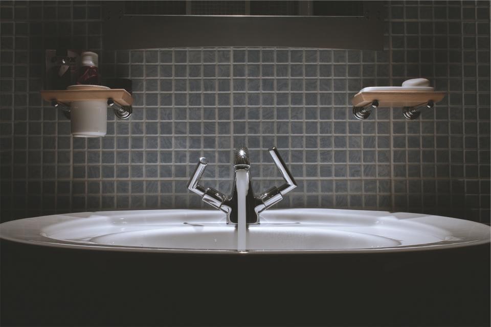 Two washbasins with taps and wall-mounted soap dispensers
