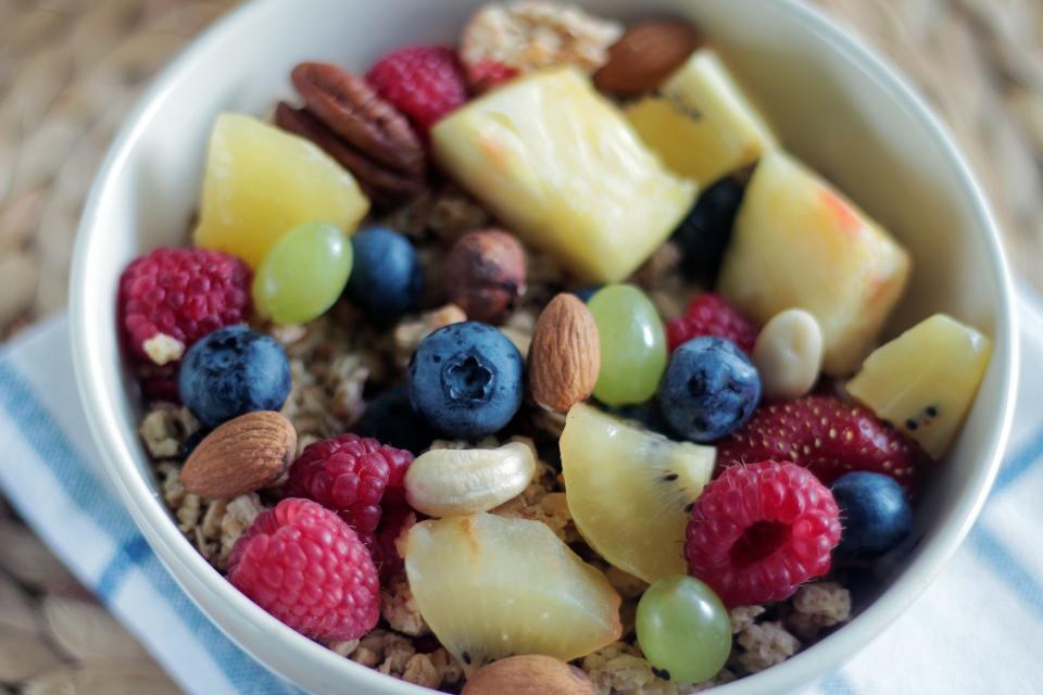 A breakfast bowl with oats, mixed fruit and nuts