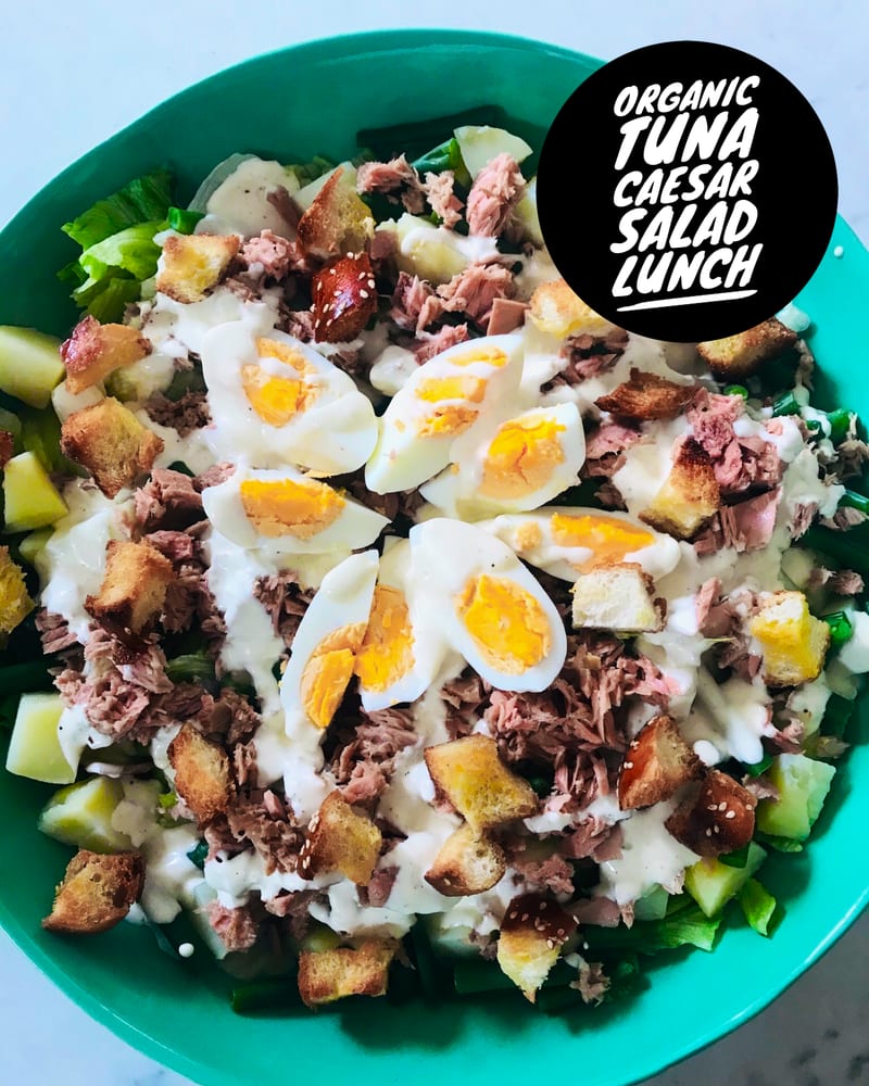 A bowl of tuna salad with egg and greens
