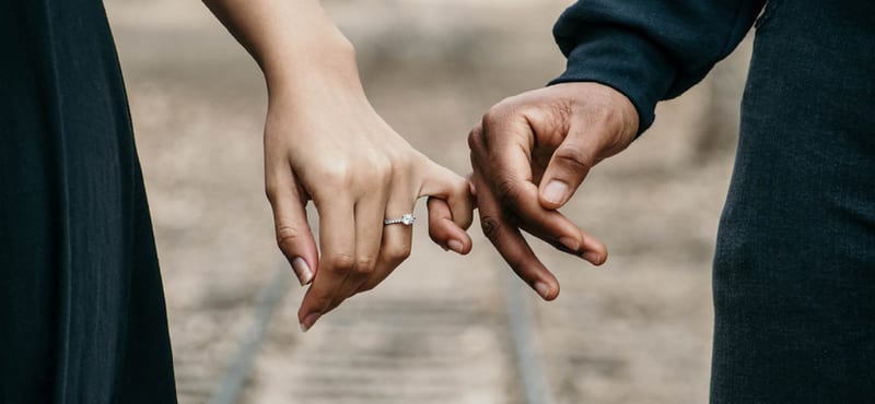 Two people holding hands